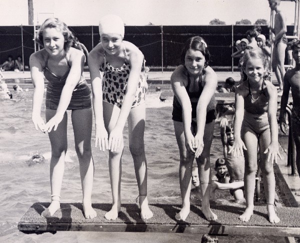 Girls ready to dive into a public pool in Arlington
